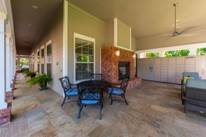 One Bedroom Apartments for Rent in Conroe, TX - Covered Outdoor Seating Area with Fireplace & Package Hub (2)      